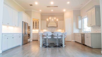 Gourmet kitchen with a large island, designer ligh