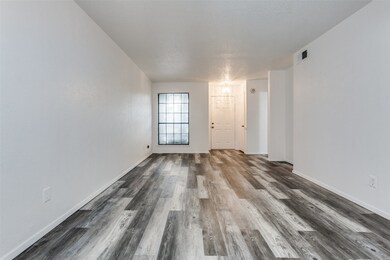 Unfurnished room with dark wood-style floors and a textured ceiling