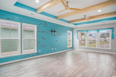 Unfurnished room with wood finished floors, ceiling fan, beam ceiling, wallpapered walls, and recessed lighting
