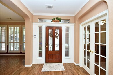It is not hard to be impressed when you walk through the mahogany front door with lead glass inserts, side lights and transom window allowing the light to flow in and fill the foyer with natural light. Beautiful cased door with plant shelf and wood look tile complete the space.