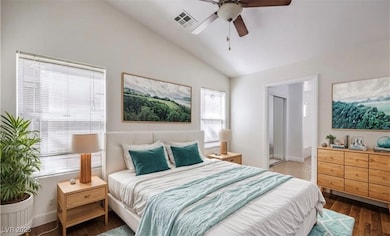 Bedroom featuring lofted ceiling, wood finished fl