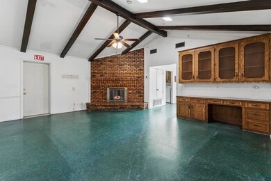 Unfurnished living room with ceiling fan, beam cei