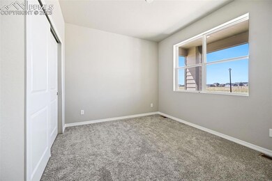 Unfurnished bedroom featuring carpet flooring, a closet, and baseboards