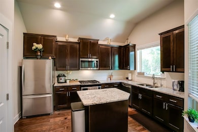 Kitchen with stainless steel appliances, a sink, 