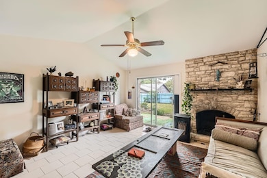 Tiled living room featuring vaulted ceiling, ceil