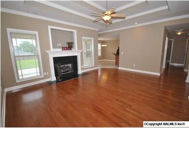 Family room w/ beautiful hardwood floors, trey ceiling, ceiling fan and fireplace.
