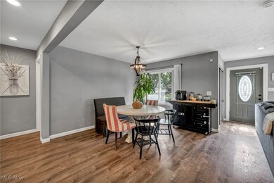 Dining room featuring dark wood-type flooring and an inviting chandelier