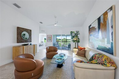 Living room featuring light tile patterned flooring and a ceiling fan