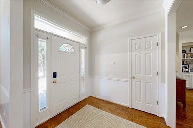 Foyer entrance with baseboards, wood finished floo