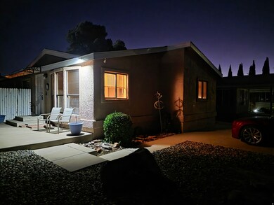 Property exterior at night featuring stucco siding