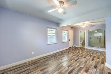 Empty room with baseboards, wood finished floors,