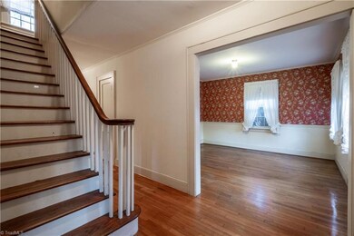 Foyer looking toward staircase and dining room.