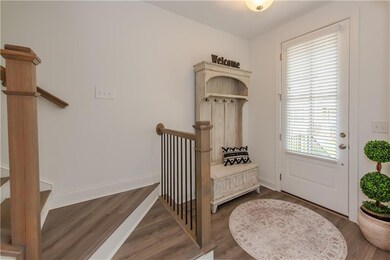 Foyer featuring wood finished floors and baseboards