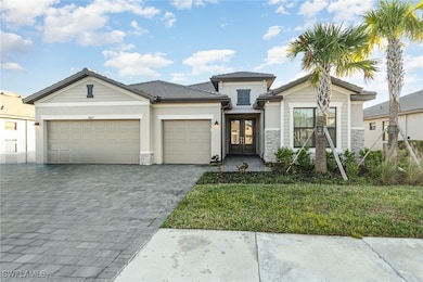 View of front of property with a front lawn, a gar
