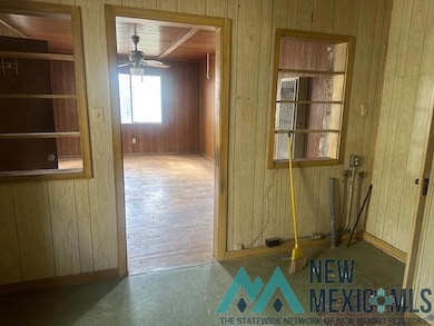 Unfurnished dining area featuring wooden walls, wooden ceiling, and ceiling fan
