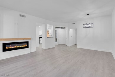 Living room with custom electric fireplace, and lu