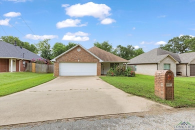 View of front of house with brick siding, concrete driveway, and an attached garage