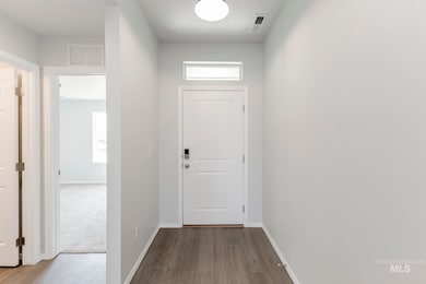 Entryway featuring baseboards and wood finished floors
