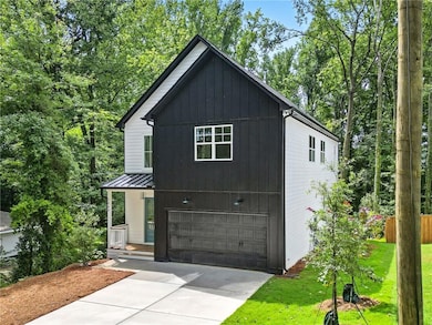 View of side of home with a standing seam roof, a metal roof, an attached garage, concrete driveway, and a porch