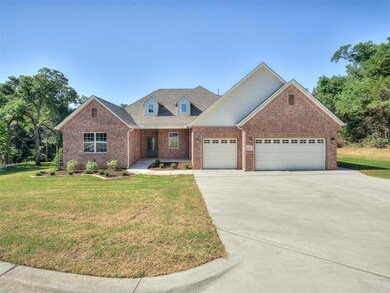 View of front of home with a garage and a front la