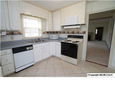 Kitchen offers plenty of storage, appliances, crown, and tile flooring