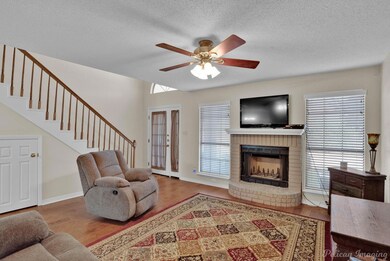 Living room featuring wood-type flooring, a wealth