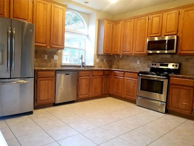 Spacious kitchen area with stainless appliances.