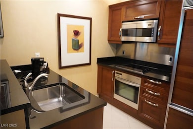 Kitchen featuring stainless steel appliances, a si