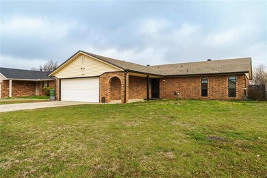 Ranch-style house featuring a garage and a front yard