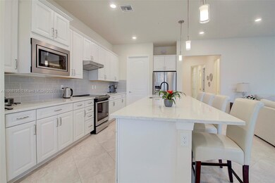 Gourmet kitchen features upgraded Maple white cabi