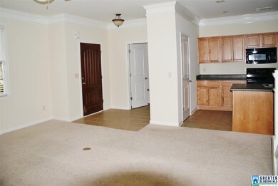 A view of entry, powder room and Kitchen.