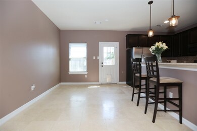 The breakfast room is open and looks out onto the compact back yard.