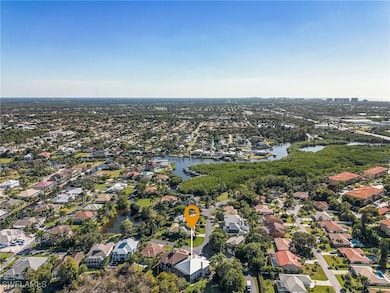 Aerial overview of property's location featuring a nearby body of water and nearby suburban area