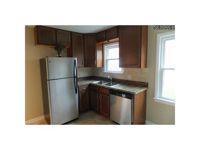Pictured is the view of the kitchen with new stainless steel refrigerator, dishwasher, garbage disposal, everything is new.  Notice the custom back splash.