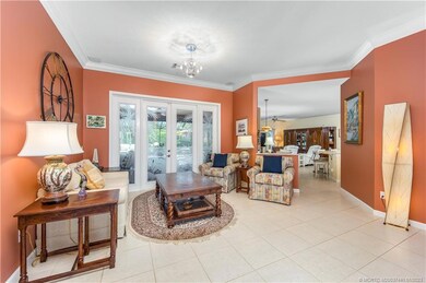 Entry way into a sitting area, with double doors l