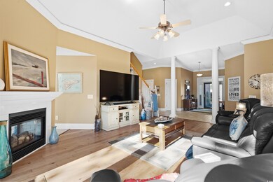 Living room featuring decorative columns, ceiling 