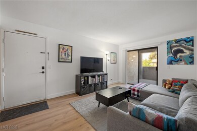 Living room with light wood-style flooring and bas