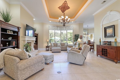 Tiled living room with a raised ceiling, crown mol
