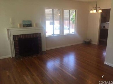 Fireplace in living room, gleaming hardwood floors