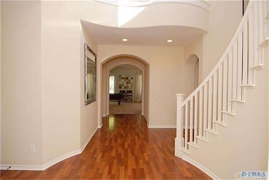 entry foyer with circular staircase and wood floor