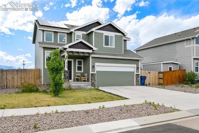 Craftsman-style house with concrete driveway, an a