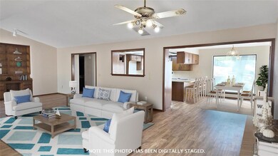 Living room with light hardwood / wood-style floor
