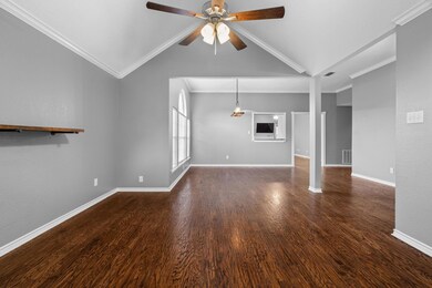 Unfurnished living room with ceiling fan, crown mo