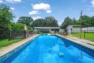 View of pool featuring an outbuilding and a patio area