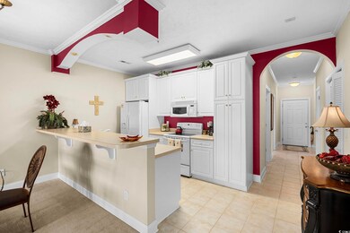 Kitchen with white cabinetry, light tile patterned