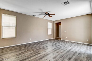 Empty room with ceiling fan, wood finished floors,