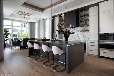 Kitchen with a breakfast bar, a tray ceiling, open