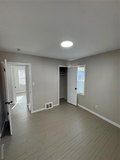 Unfurnished bedroom featuring baseboards and light wood-type flooring