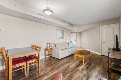 Living area featuring visible vents, baseboards, a
