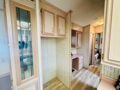 Bathroom with light wood-style floors and ornamental molding
